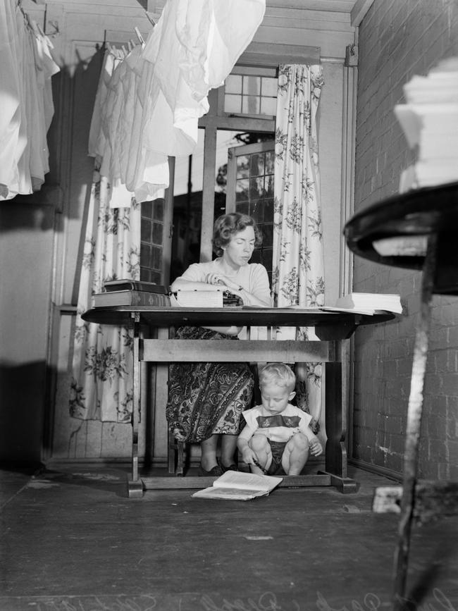Park at work as her child plays at her feet. Picture: Mitchell Library, State Library of New South Wales