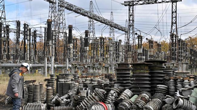 A worker examines damage after a missile strike on a Ukraine power plant. Picture: AFP.