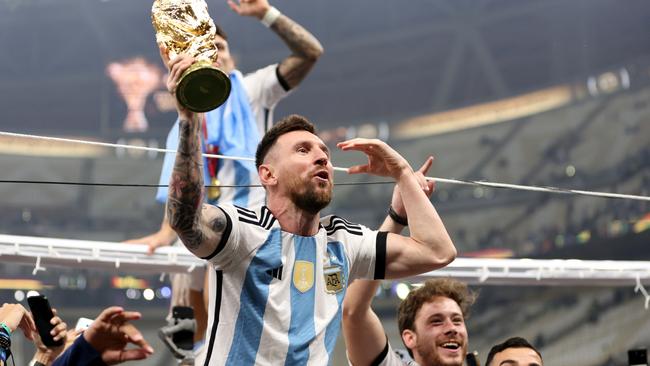 Lionel Messi of Argentina celebrates with the FIFA World Cup Qatar 2022 Winner's Trophy.