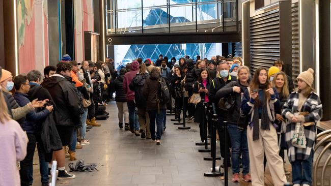 Queues outside the Melbourne Passport Office in Docklands. Picture: Tony Gough