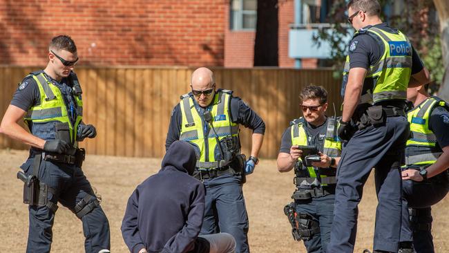 Police talk with a man during a drugs crackdown near Victoria St, Richmond. Picture: Jason Edwards