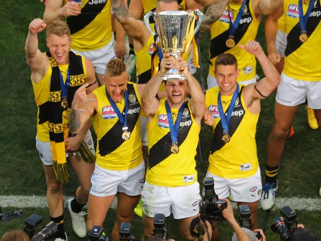 MELBOURNE, VICTORIA - SEPTEMBER 30:  Trent Cotchin of the Tigers, Dustin Martin of the Tigers celebrate with the the AFL Premiership Cup and supporters in the crowd as the Tigers make their way to the changing rooms after winning  the 2017 AFL Grand Final match between the Adelaide Crows and the Richmond Tigers at Melbourne Cricket Ground on September 30, 2017 in Melbourne, Australia.  (Photo by Scott Barbour/AFL Media/Getty Images)