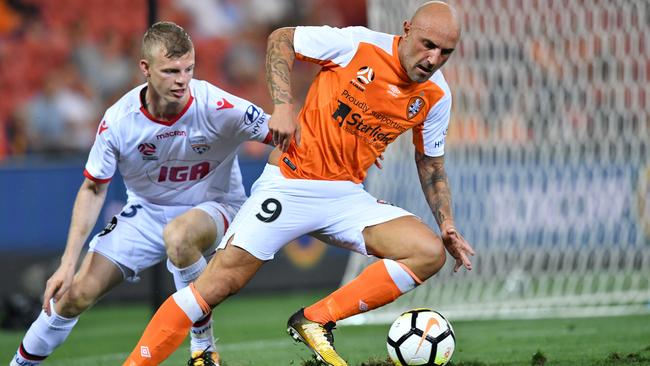 Massimo Maccarone glides past Jordan Elsey of Adelaide.