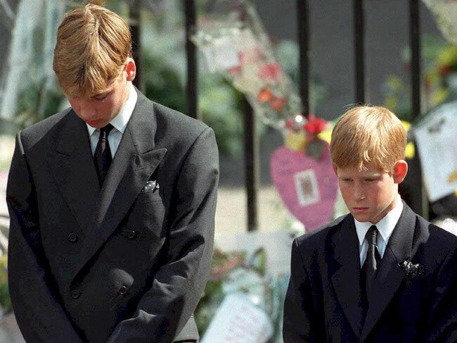 In1997 Prince William (left) and Prince Harry, the sons of Diana, Princess of Wales, bow their heads as their mother's coffin is taken out of Westminster Abbey following her funeral service. Picture: AFP