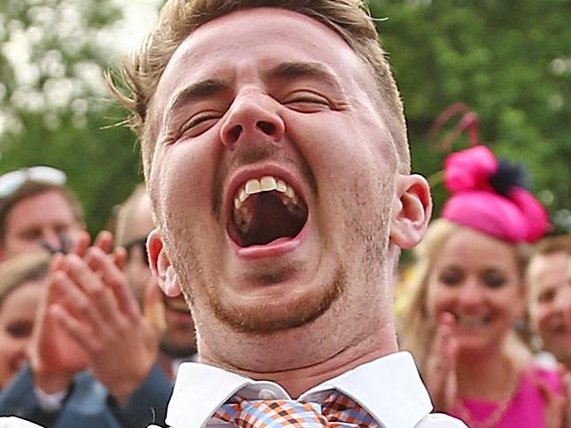 MELBOURNE, AUSTRALIA - NOVEMBER 03: Racegoers celebrate as a man successfully bends backwards between two racegoers who have their ties tied together as racegoers play a game of Limbo following 2015 Melbourne Cup Day at Flemington Racecourse on November 3, 2015 in Melbourne, Australia. (Photo by Scott Barbour/Getty Images)