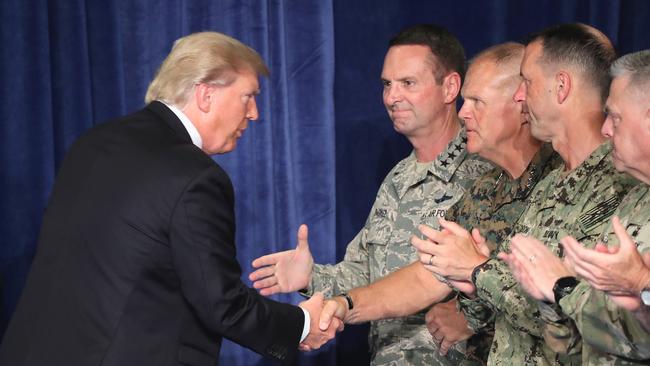 Donald Trump greets military leaders before his speech on Afghanistan at the Fort Myer military base.