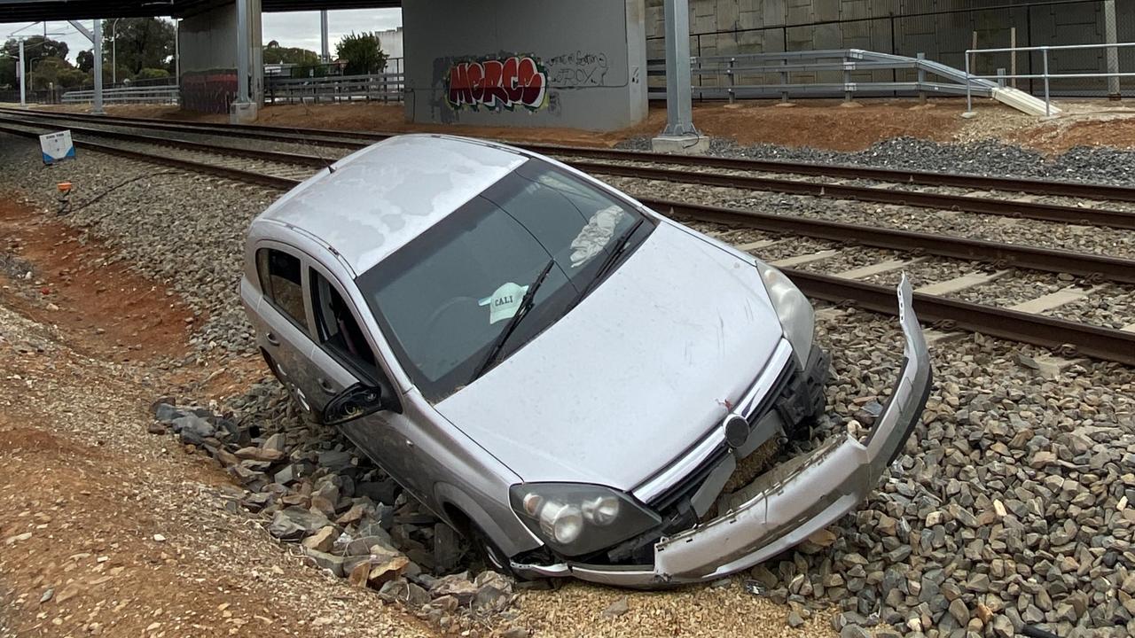 Alleged disqualified driver crashes car on to train tracks | The Advertiser