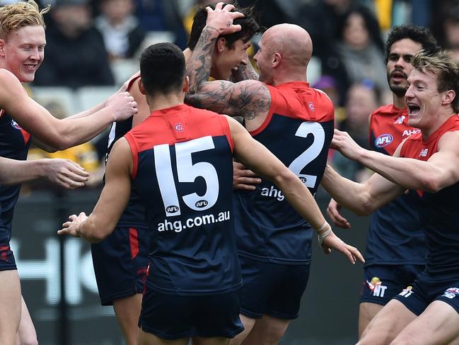 Sam Weideman (fourth from left) i s embraced by teammates after he kicked his first AFL goal during the Round 20 AFL match between the Melbourne Demons and the Hawthorn Hawks at the MCG in Melbourne, Saturday, Aug. 6, 2016. (AAP Image/Julian Smith) NO ARCHIVING, EDITORIAL USE ONLY