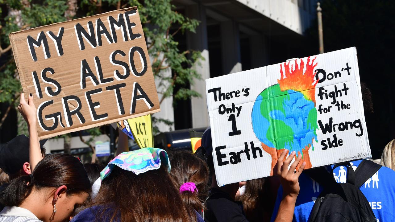Activists hold placards before a march through downtown Los Angeles, US, during a climate change rally where teenage Swedish activist Greta Thunberg addressed the crowd on November 01, 2019. Picture: AFP