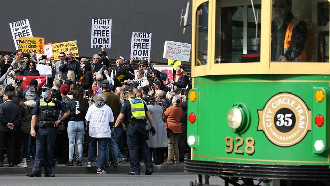 Protesters are met by police. Picture: Ian Currie