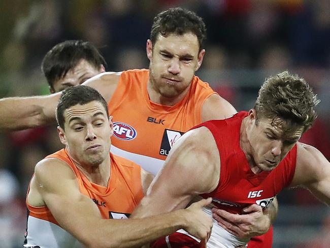 Giants Josh Kelly and Shane Mumford tackle Sydney's Luke Parker during AFL match GWS Giants v Sydney Swans at Spotless Stadium. Picture. Phil Hillyard