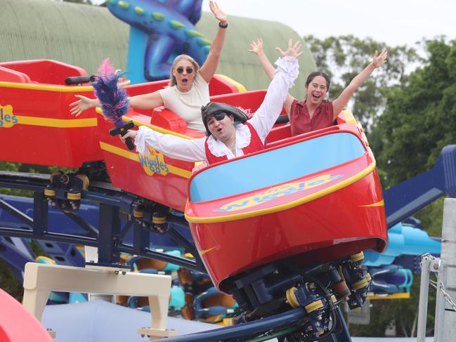 Test riding the new Wiggles Big Red Boat ride are Captain Feathersword with Dreamworld staff members Homare Atkinson and Casey Barton. Picture Glenn Hampson
