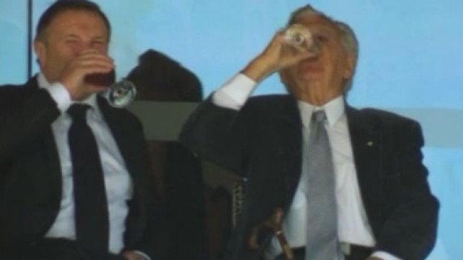 Bob Hawke (right) necks a beer at the Sydney Test match.