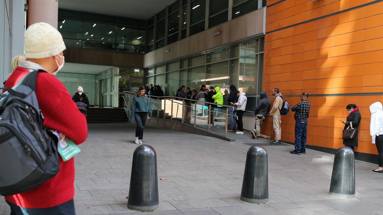 People are seen queuing up outside the Passport Office in Sydney on Tuesday. Picture NCA NewsWire / Gaye Gerard