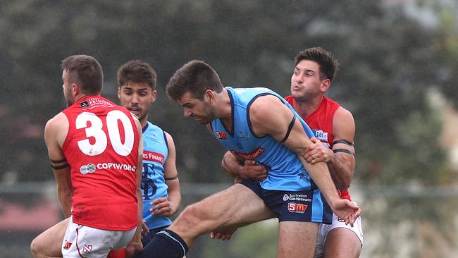 Max Thring smothers a kick from Thomas Read, tackled by Aidan Tropiano. Picture: Tait Schmaal