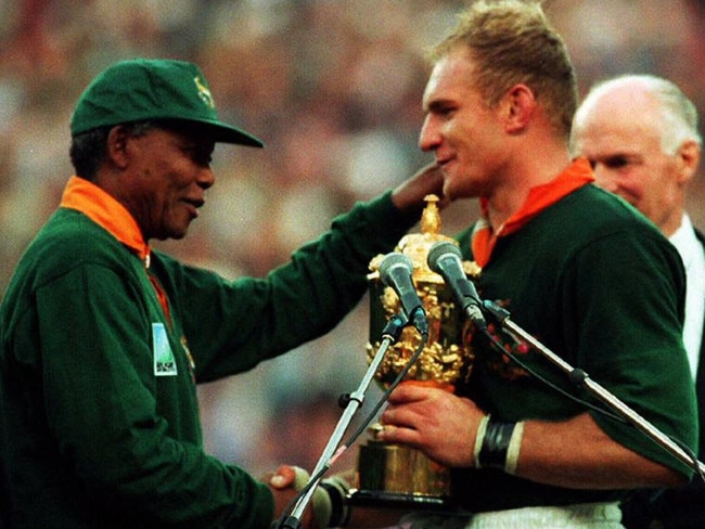 South African President Nelson Mandela, left, hands over William Webb Ellis Cup trophy to Springboks captain Francois Pienaar after South Africa defeated New Zealand All Blacks in 1995 World Cup final at Ellis Park in Johannesburg. Picture: AFP