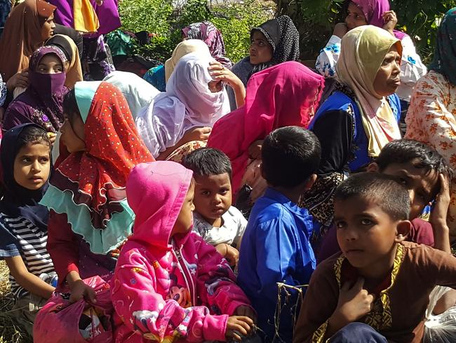 Rohingya refugees, who landed on an isolated northern shore near the Malaysia-Thai border, huddle in a group in Kangar. Picture: AFP