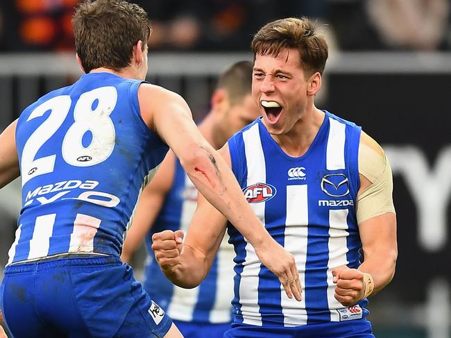 HOBART, AUSTRALIA - MAY 06:  Nathan Hrovat of the Kangaroos is congratulated by Kayne Turner after kicking a goal during the round seven AFL match between the North Melbourne Kangaroos and the Adelaide Crows at Blundstone Arena on May 6, 2017 in Hobart, Australia.  (Photo by Quinn Rooney/Getty Images)