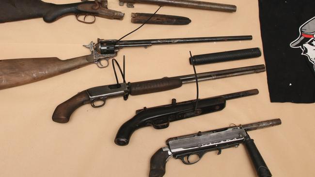 Taskforce Maxima executed a search warrant at a Queensland address at 2019; locating and seizing six firearms, a silencer, ammunition and Rebels Outlaw Motorcycle Gang clothing buried in the backyard. Picture: Queensland Police