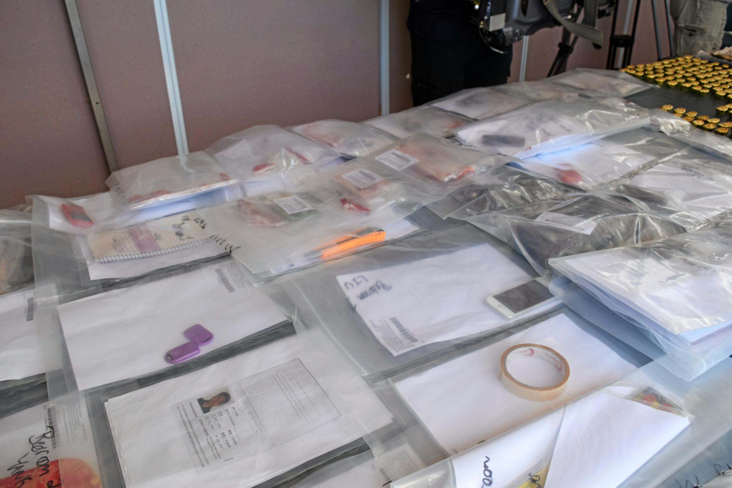 Fake documents, passports and mobile phones were seized by police who allege the property was used as part of a scam. Picture: Chloe Lyons