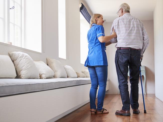 AGED CARE/NURSING HOME/SENIOR/RESIDENTIAL CARE. Picture: istock   Nurse helping senior man walk using a walking stick