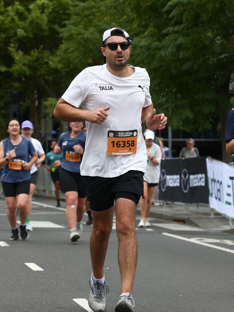 Run For The Kids long course finishers orange bibs. | Herald Sun