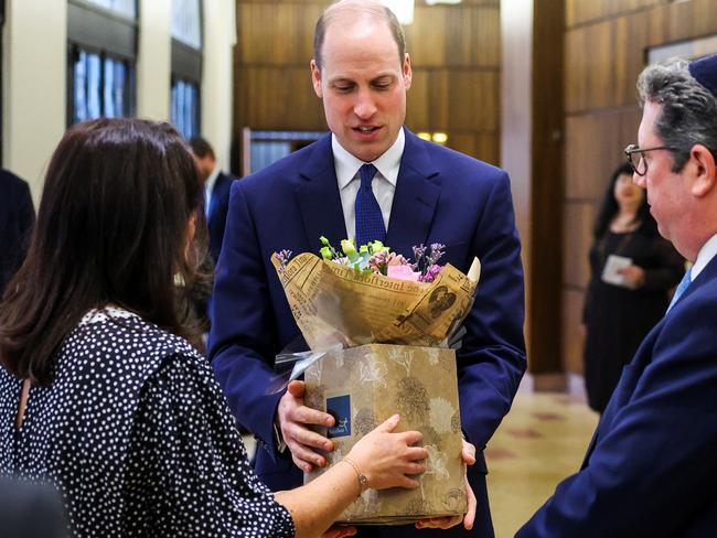 Prince William receives a bouquet of flowers for his wife Catherine, during a visit to the Western Marble Arch Synagogue in London. Picture: Getty Images