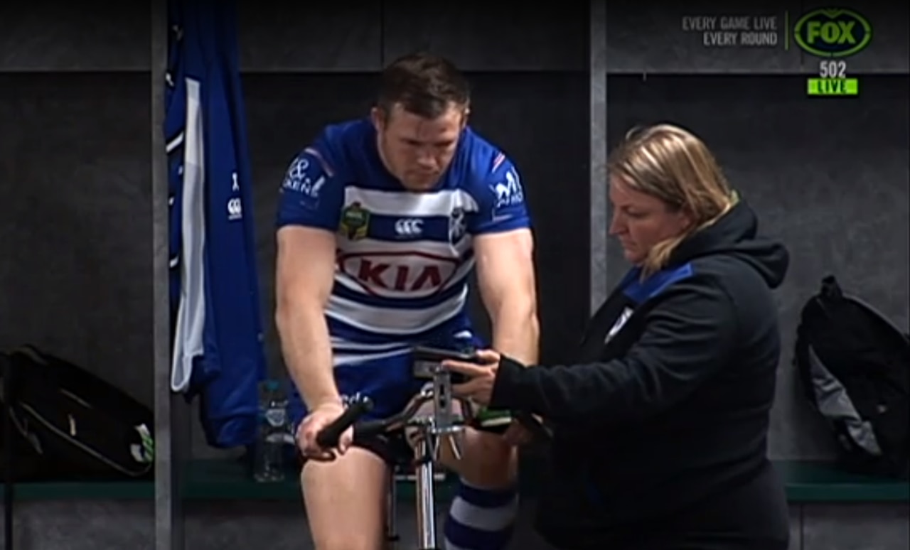 A Bulldogs staff member holds up a phone for Brett Morris during his 10 minutes in the bin.