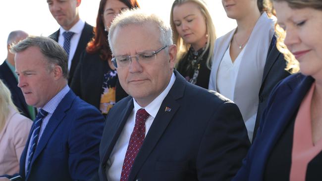 Australian Prime Minister Scott Morrison (centre), Tasmanian Premier Will Hodgman (left) and Hobart Mayor Anna Reynolds (right) sign the Hobart City Deal at Hobart Airport.. Picture: Rob Blakers/AAP