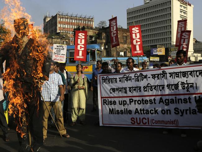 Activists of Socialist Unity Center of India-Marxist burn an effigy of Donald Trump in Kolkata, India, in protest over the air strikes. Picture: AP Photo/Bikas Das