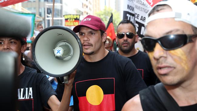 James Roberts on the megaphone during the march. Picture: Jonathan Ng