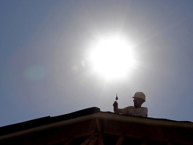 A roofer works under the midday sun in Gilbert, Arizona. Pic: AP Photo