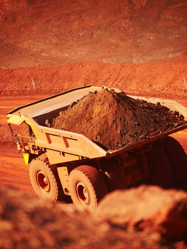 Iron ore being trucked out of an open cut mine. Picture: AFP