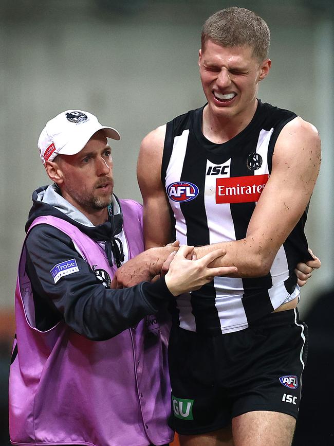 The agony: Kelly finished the game in the hands of trainers after suffering a serious injury. Picture: Getty Images