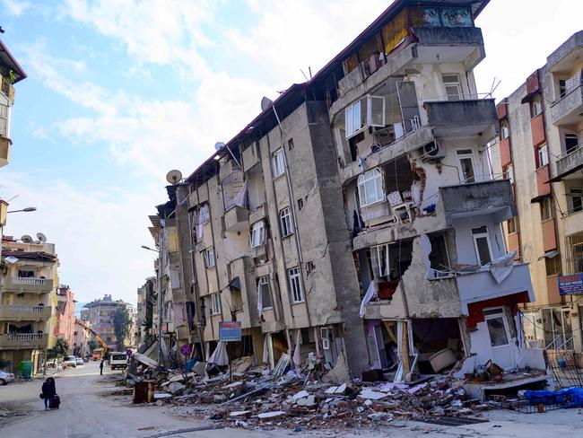 A local resident walks past a destroyed building in Hatay, Turkey. Picture: AFP