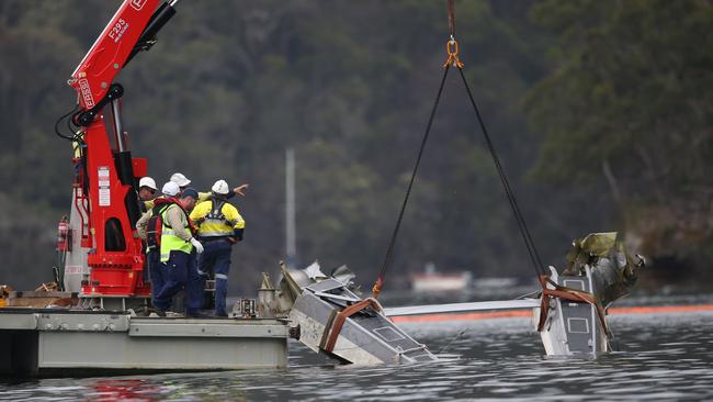 The seaplane’s wreckage is pulled from the water at Jerusalem Bay in Sydneys Hawkesbury river. Picture: Richard Dobson..