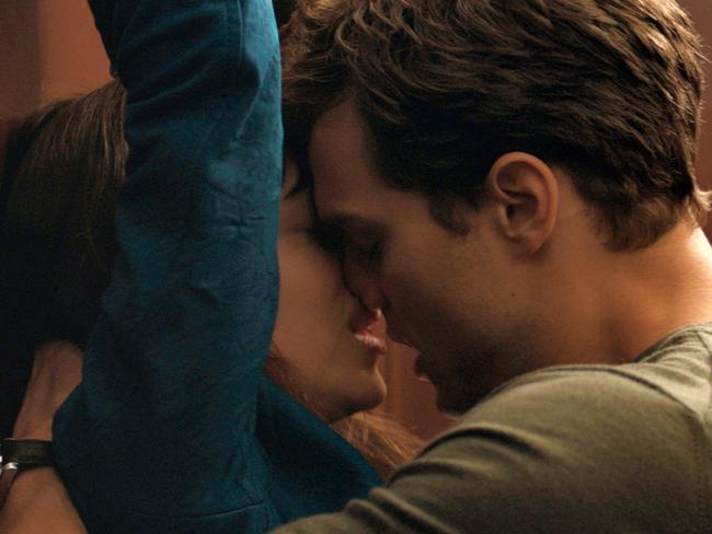 In this image released by Universal Pictures and Focus Features, Dakota Johnson, left, and Jamie Dornan appear in a scene from "Fifty Shades of Grey." The film is getting a big thumbs-down from religious and other groups who say it’s degrading to women and endorses sexual violence. One social media campaign is encouraging movie-goers to instead give their ticket and popcorn money to women’s shelters. Author EL James, who wrote the erotic trilogy that launched the film, has heard the backlash and says the critics have it all wrong. She says no woman wants to read about abuse, and that everything that happens is safe and consensual. (AP Photo/Universal Pictures and Focus Features)