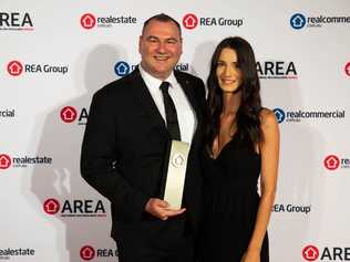 Mark McGill has been highlighted as an industry trailblazer after he picked up a perfect score and national award at the realestate.com.au AREAs. Pictured with sales associate Alana Luchetta.