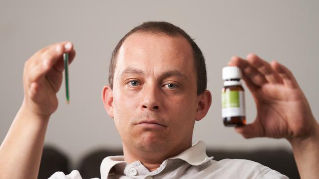 Brenton Peters with the cannabis oil he uses to treat his multiple sclerosis. Picture: Matt Loxton