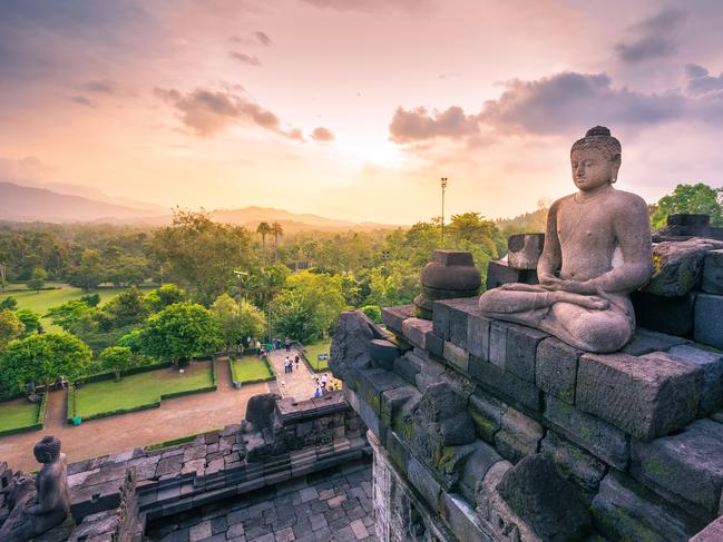 Carved stone buddha statue in small stupa around top of Borobudor, world largest buddhist temple in Yogyakarta, Indonesia. Picture: iStockBrad Crouch, Escape