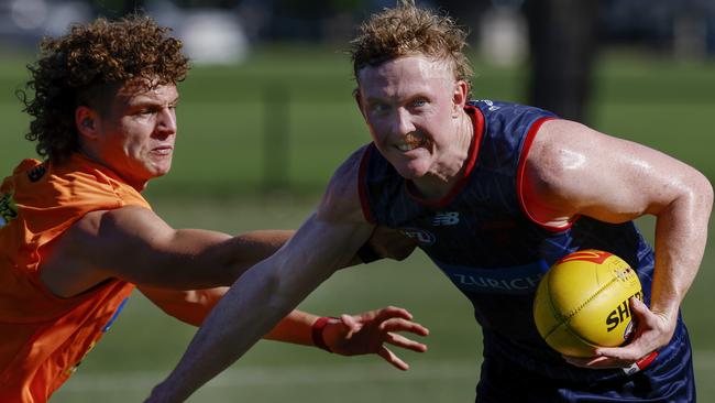 MELBOURNE , AUSTRALIA.February 12 , 2024.  Melbourne AFL football training at Goschs Paddock. Clayton Oliver of the Demons  fends off Koltyn Tholstrup  . Pic: Michael Klein