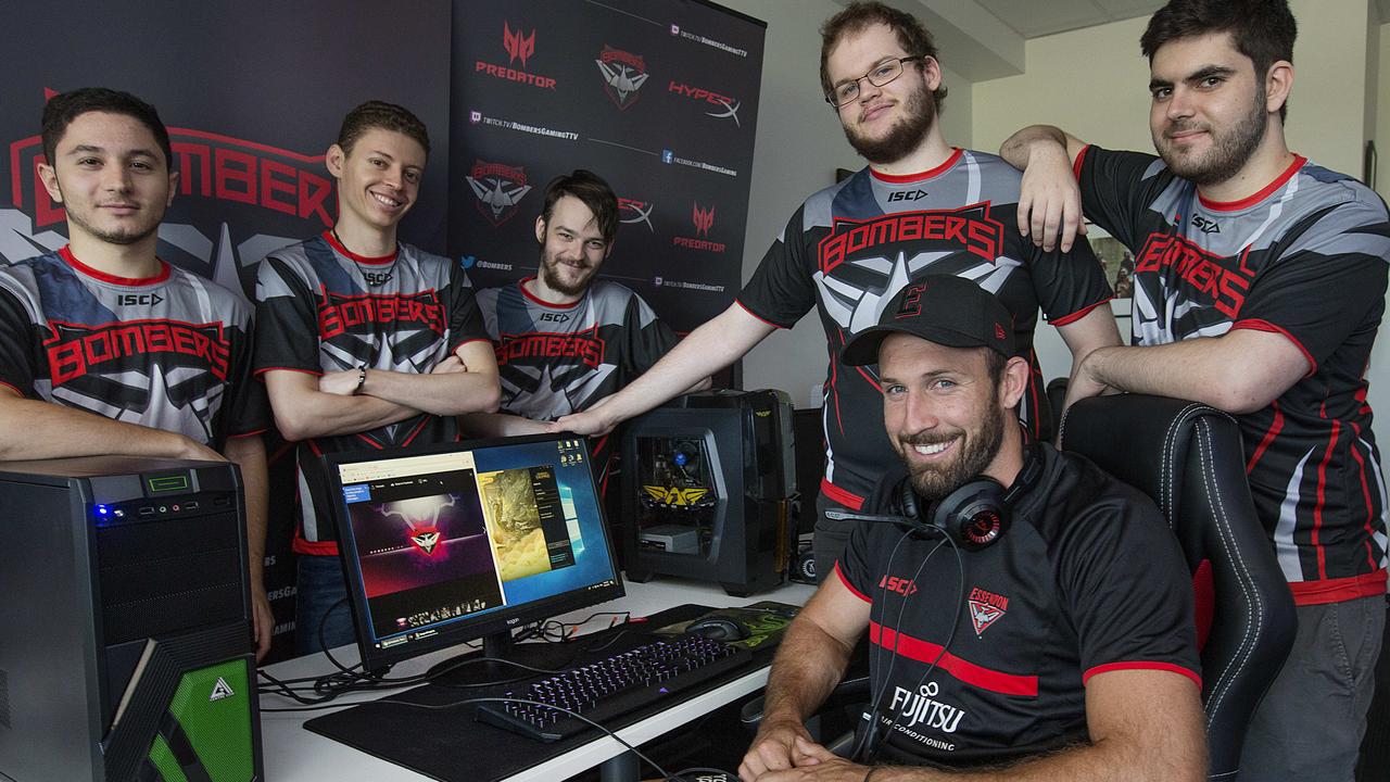 Essendon’s esports team, Bombers, has qualified for the gauntlet stage (finals) of the League of Legends Oceanic Pro League. Here Cale Hooker sits with players Carlo ‘Looch’ La Civita, Alan ‘Tiger’ Roger, Andrew ‘Rosey’ Rose, Christian ‘Sleeping’ Tiensuu and Sebastian ‘Seb’ de Ceglie. Picture: Ian Currie