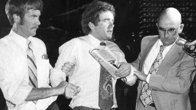 0’Gorman being led out of Queensland’s parliamentary annexe by plainclothes police in 1980.