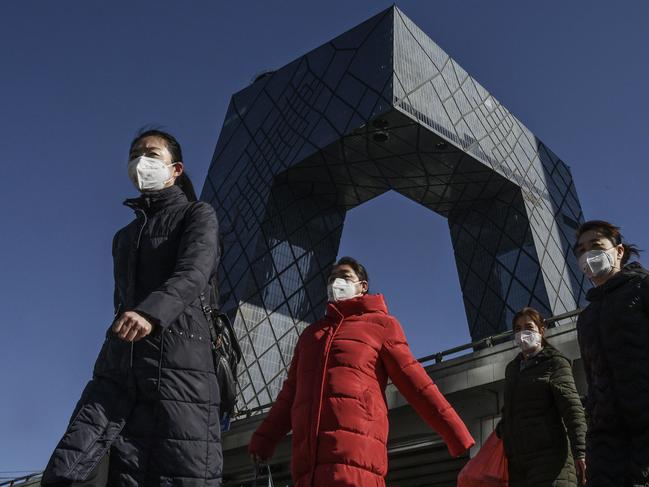 Chinese women wear protective masks in Beijing. Picture: Getty