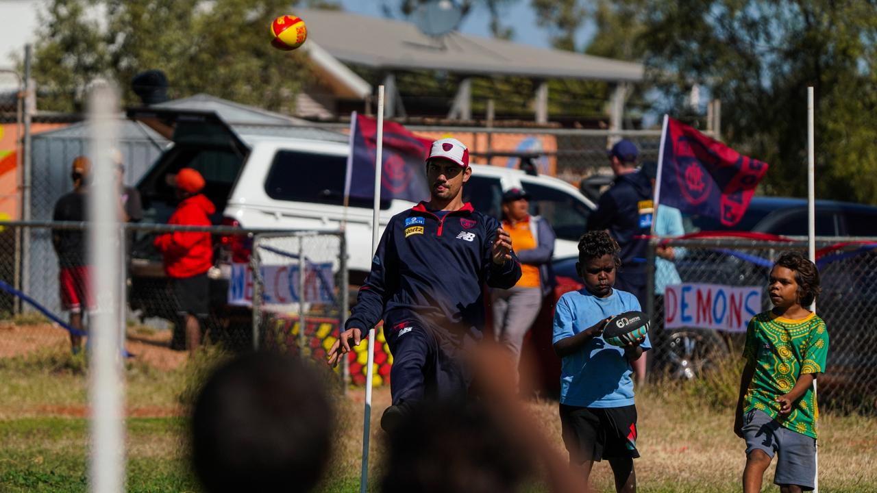 Melbourne Demons players Shane McAdam and Andy Moniz-Wakefield went to Santa Teresa ahead of the 2025 AFL game in Alice Springs. Picture: Melbourne Demons