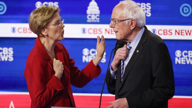 Elizabeth Warren talks with Senator Sanders on stage after the Democratic presidential primary debate. Picture: AP