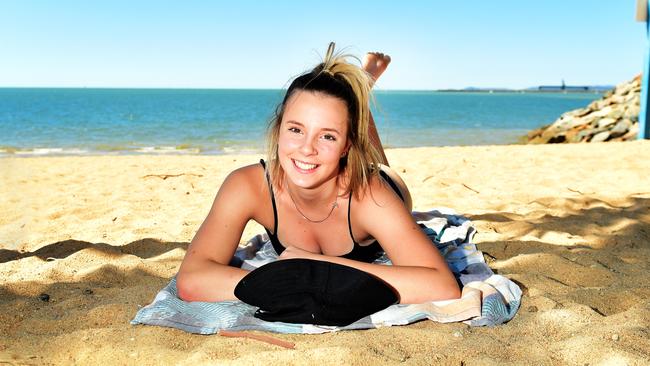 Mia Healey 14, on holidays from Moama, NSW, sunbakes on the Strand, Townsville.