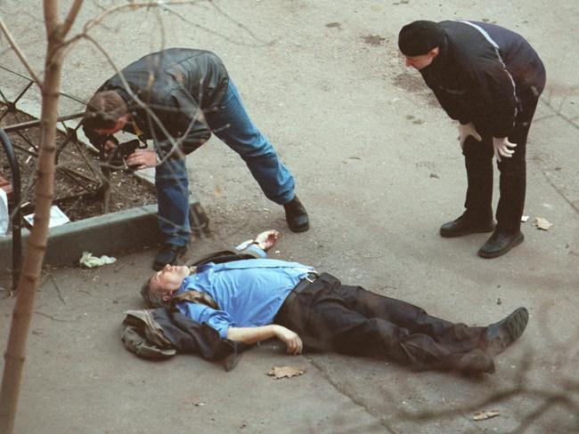 Investigators view body of assassinated leader of Liberal Russia party Sergei Yushenkov at scene where he was shot to death in street near his apartment building in Moscow.