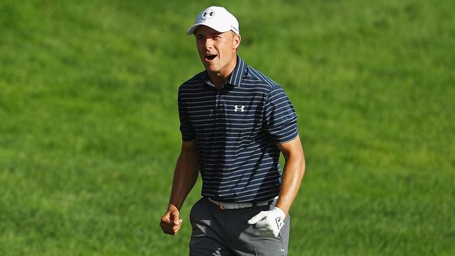 Jordan Spieth of the United States celebrates after chipping in for birdie from a bunker on the 18th green to win the Travelers Championship in a playoff against Daniel Berger.
