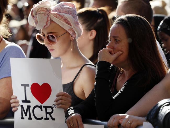 People attend a vigil in Albert Square, Manchester, England.  Picture:  AP